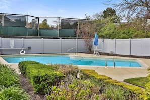 The pool is on the grounds and a 2-3 minute walk from the house on the way to the beach and next to the tennis courts.