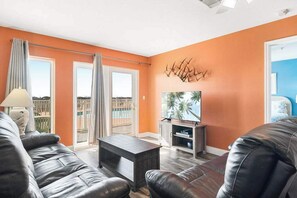 Relax in the spacious living room with direct outdoor access, just steps away from the community pool—perfect for a seamless blend of indoor comfort and outdoor fun.