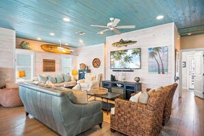 Step inside and get ready to kick back—this cozy living room is where the coastal good vibes start! Perfect for chilling, chatting, and making memories. Welcome to your happy place!

