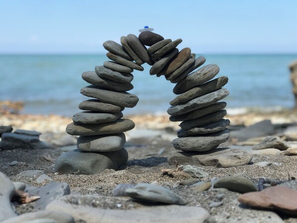 The rocky beach is great for long walks, sunbathing, and swimming.