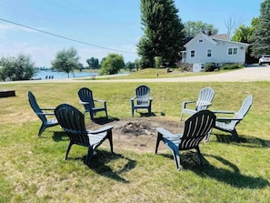 Enjoy lake views at your private fire pit. (Local wood sold on-site)