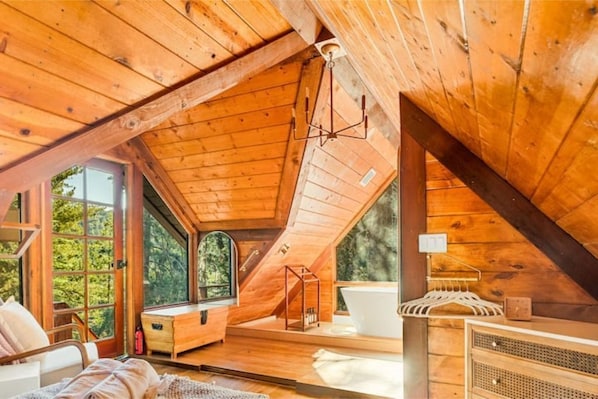 Dreamy master suite with woodpaneling throughout.