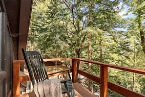 Enjoy our rocking chair on the top most deck with a treeline view.