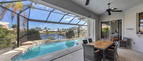 Spacious outdoor area with dining table overlooking the water