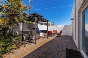 Private patio featuring a BBQ grill and a lounge area with a firepit for those cool desert nights.