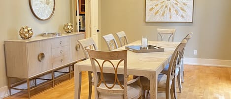 Beautiful, bright dining room with vaulted ceilings and streaming sunlight