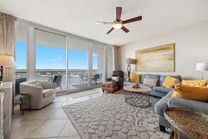 Spacious and inviting living area with floor-to-ceiling windows showcasing breathtaking panoramic views. This open-concept design seamlessly blends comfort and style, creating the perfect space for relaxation and entertainment.