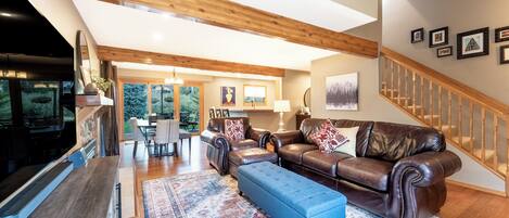 Large living room with ample seating, Smart TV and gas fireplace.