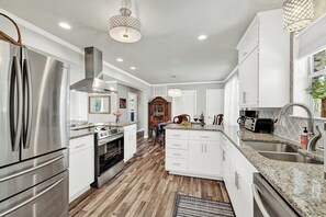 Large kitchen with stainless steel appliances.