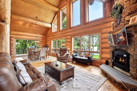 Beautiful real log constructions with massive windows overlooking the lake