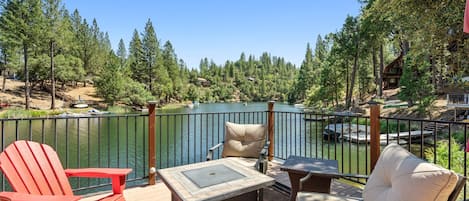 Deck seating and fire pit overlooking the lake.