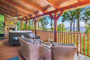 Expansive deck with hot tub outdoor fireplace, plenty of outdoor seating & grill