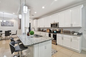 This modern kitchen is fully equipped with everything you need to cook delicious meals during your stay.