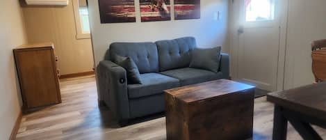 living area with  full size hide a bed love seat