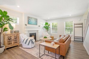 Living room with seasonal gas fireplace and Smart TV