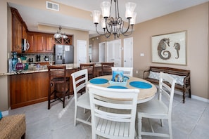 DIning area - A 4 top table and extra seating at the countertop bar.