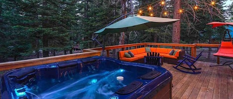 Enjoy the expansive back deck with outdoor lounge furniture, gas grill and private hot tub!