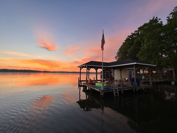 Our dock at sunset- sit and enjoy or take out a complimentary float or kayak!