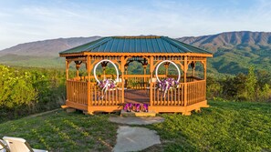 "Outdoors","Gazebo","Shelter","Chair","Nature"