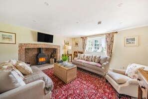 Crumpet Cottage, Chebbard, Dorchester: The attractive sitting room with wood burning stove