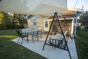 Patio: Fire up the charcoal grill & enjoy the furnished patio, canopy, & lights 