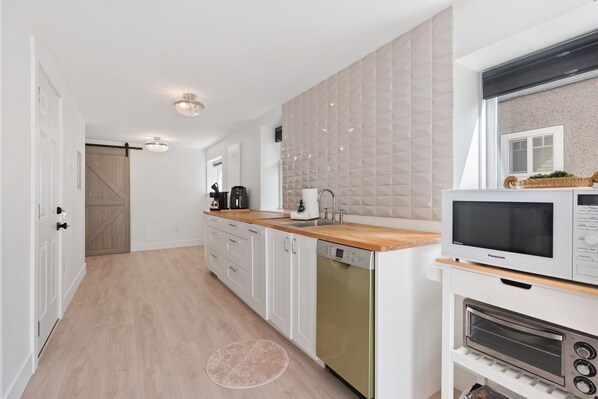 Kitchen area with fridge n airfryer microwave n toaster oven
