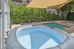 A hot jacuzzi for four is next to a cold pool, it’s perfect for health benefits.