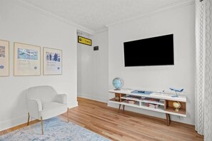 The Lounge: TV, sofa a chair with views to the street (2)