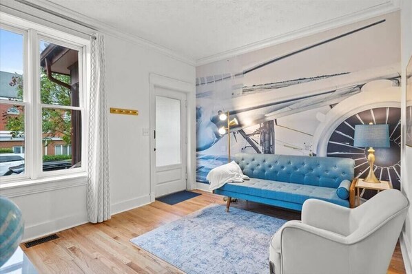The Lounge: TV, sofa a chair with views to the street (1)