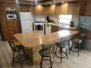 Kitchen and counter with bar stools