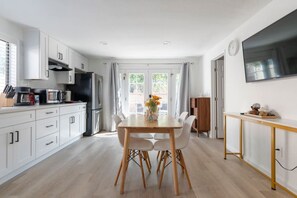 The dining area in our charming kitchen is perfect for enjoying a delicious meal or sipping your morning coffee.