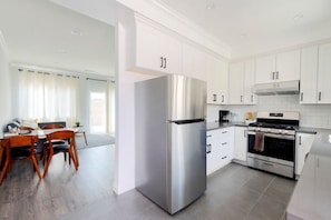 Enjoy a culinary experience in our fully equipped kitchen, featuring a wide countertop and all the essentials including a dishwasher and coffee maker.