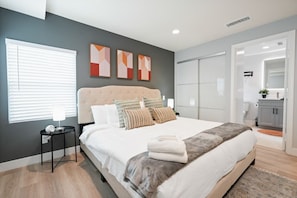 Indulge in Opulence: Enjoy the Wall-mounted 50-inch TV and Private Bathroom in Your Room.