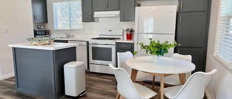 The fully-equipped kitchen features modern appliances and all cooking/dining essentials.
