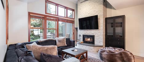 Cozy living area with a smart TV and wood burning fireplace.