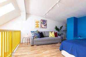 Bedroom in the upper level of the apartments with queen size bed and convertible sofa