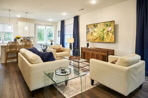 Open layout with large smart television and ample, leather seating.