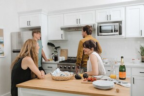 Enjoy a night of fun and connection in our sleek, modern kitchen! This spacious, fully-equipped area is perfect for gathering with friends, whipping up delicious meals, or hosting a lively dinner party