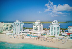 Aerial view of the resort, Oleo Cancun Playa.  Penthouse Combo #204 is located on the Penthouse level of the center tower, top floor, 7th.  Photo Order: Terraces, Main areas, bedrooms/bathrooms, resort photos, what’s nearby.