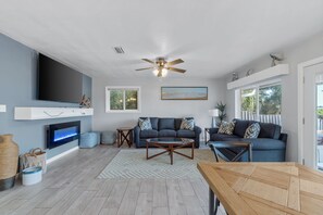 Living room with 75" smart tv and electric fireplace