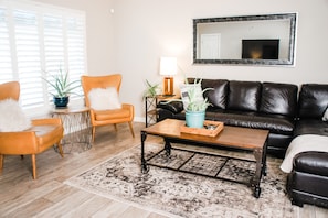 Living Room with Leather Sectional and Twin Leather Wingback Chairs