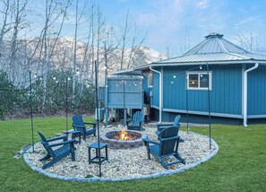 Pristine fire pit, Adirondack chairs, and string lights!  Seasonal mountain views!