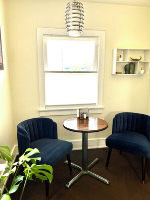 Small dining area with two chairs and round table. 