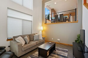 Kitchen and dining overlooks living room & patio