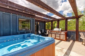 - Relax in the bubbling hot tub while surrounded by fresh mountain air
- Fire up the stainless steel grill and enjoy an open air cookout with ease
- String lights and rustic beams create the perfect vibe for evening lounging