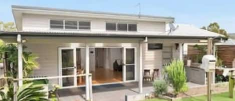 Back garden and covered outdoor dining area.