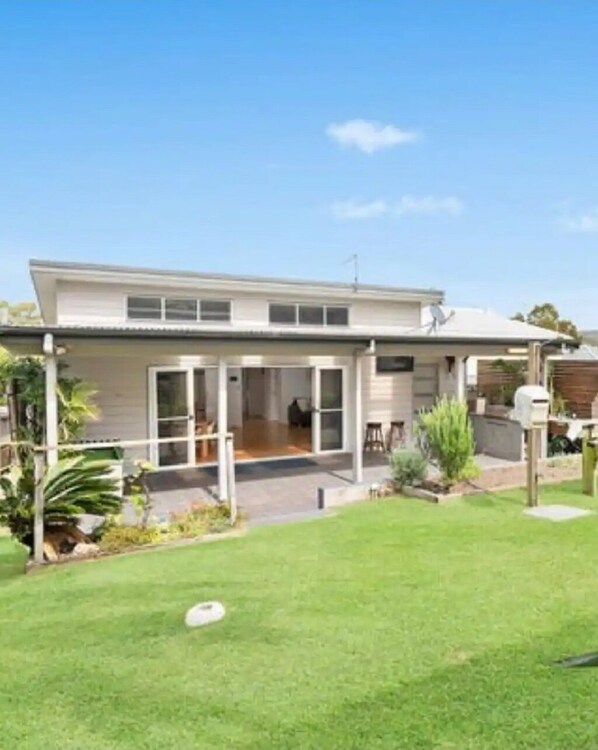 Back garden and covered outdoor dining area.