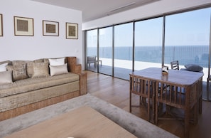 Living room with ocean view, TV.