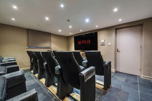 15 seat cinema in cellar with75 inch Smart TV.