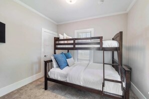 Guestroom 1: Features a twin-over-double bunk bed, as well as a large closet and smart TV. Enjoy a comfortable stay with everything you need right in your room